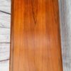 A G Plan Astro Mid Century Modern Vintage Teak Coffee Table from the 1960s, showcasing a smooth, polished surface with a rich, warm brown hue and distinct wood grain patterns. The table is set against a white-washed wooden background that features visible textures and a decorative emblem in the top right corner.