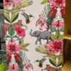 A hand-painted Tallboy cabinet showcases a detailed, vibrant nature scene featuring parrots, hummingbirds, cheetahs, an elephant, and various pink flowers amidst lush green foliage. The colorful animals and plants are intricately patterned on a pale background, making it a stunning piece of upcycled bedroom or kitchen storage ideal for clothes organization.