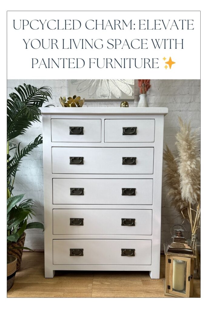 A white painted chest of drawers with brass handles is placed in a cozy living space. The area is decorated with plants, a gold lantern, and decorative items. The text "Upcycled Charm: Elevate Your Living Space with Painted Furniture ✨" overlays the top of the image.