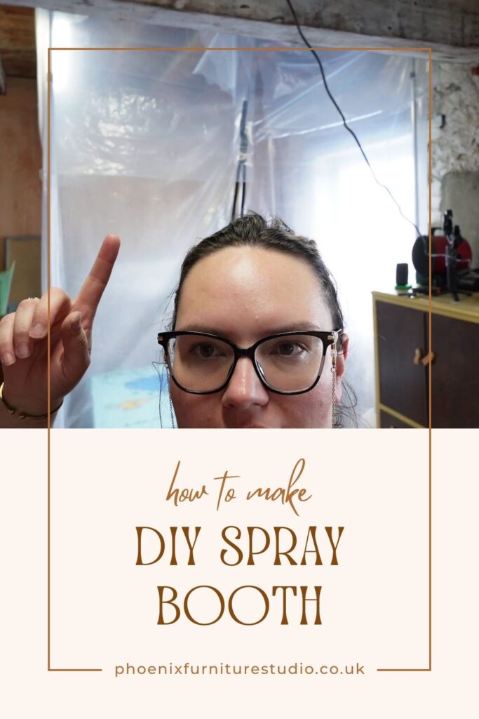 A person wearing glasses points upwards with one finger. The background shows a covered workspace. Overlay text reads: "how to make DIY Spray Booth" with a website link "phoenixfurniturestudio.co.uk" at the bottom.