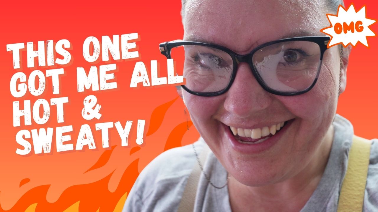 A person with glasses smiles into the camera, with lenses fogged up, against a vibrant orange background with an illustrated flame. The text reads, "THIS ONE GOT ME ALL HOT & SWEATY!" An "OMG" in a comic-style burst is on the top right.