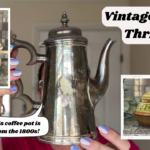 A person holds a tarnished metal coffee pot from the 1800s. Inset images show a blue and white ceramic jar and a brown dish with a lid. Text reads: "Vintage Decor Thrift Haul Part 1." The person has blue nail polish.