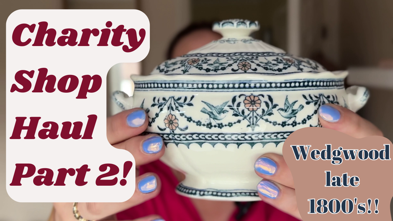 A person holds a vintage Wedgwood dish with intricate blue floral patterns. Text reads "Charity Shop Haul Part 2!" and "Wedgwood late 1800's!!" The person's nails are painted in lavender.